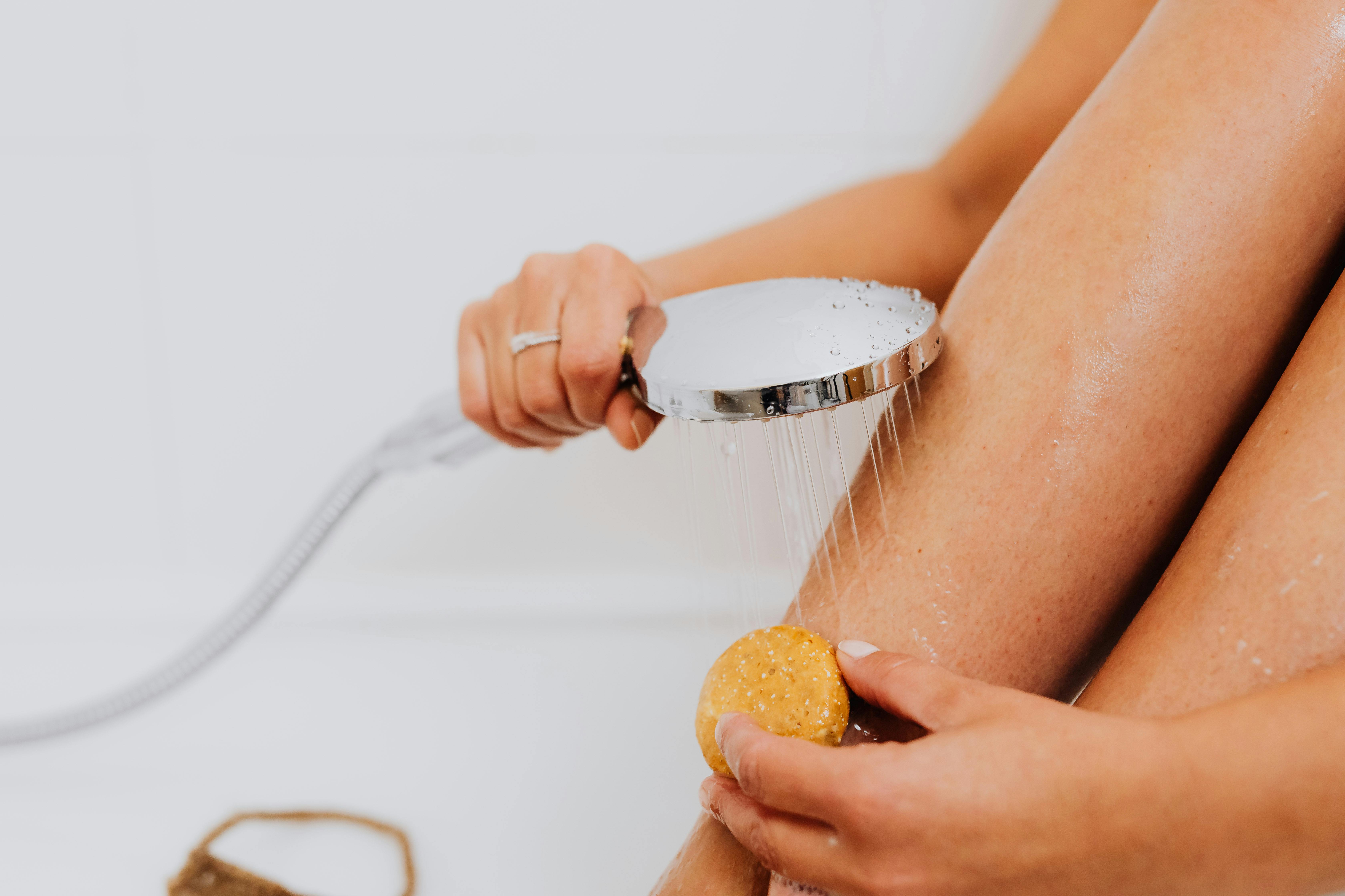 A woman exfoliating her skin | Source: Pexels