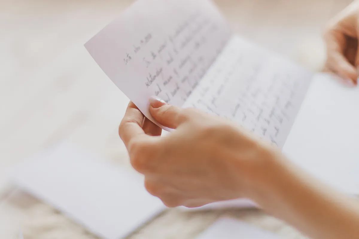 A person holding a handwritten letter | Source: Shutterstock