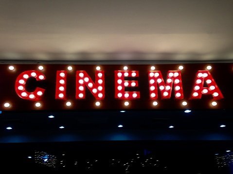 Photo of an illuminated single word "cinema" on a wall  | Photo: Getty Images