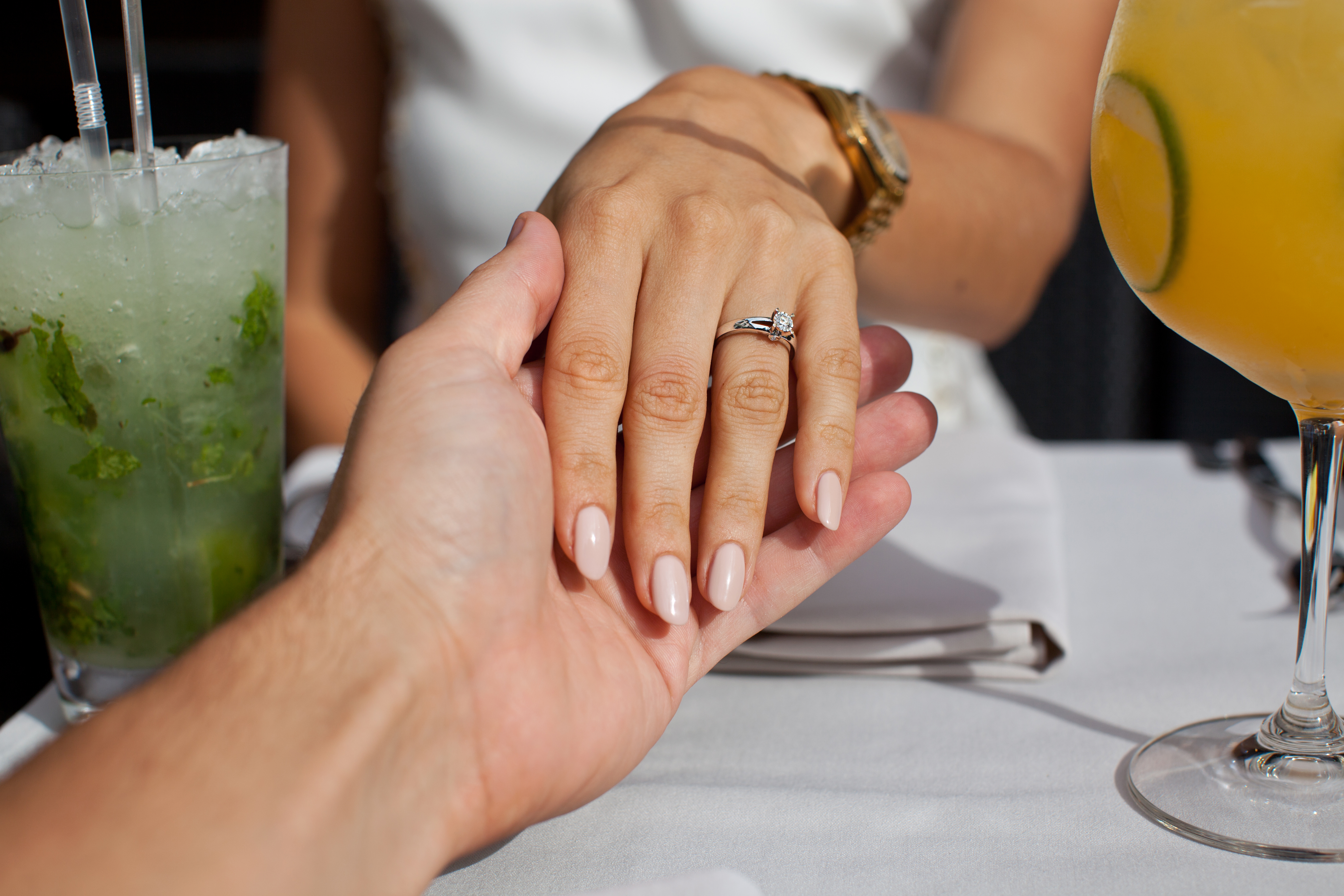 A man holding a woman's hand adorned with an engagement ring | Source: Shutterstock