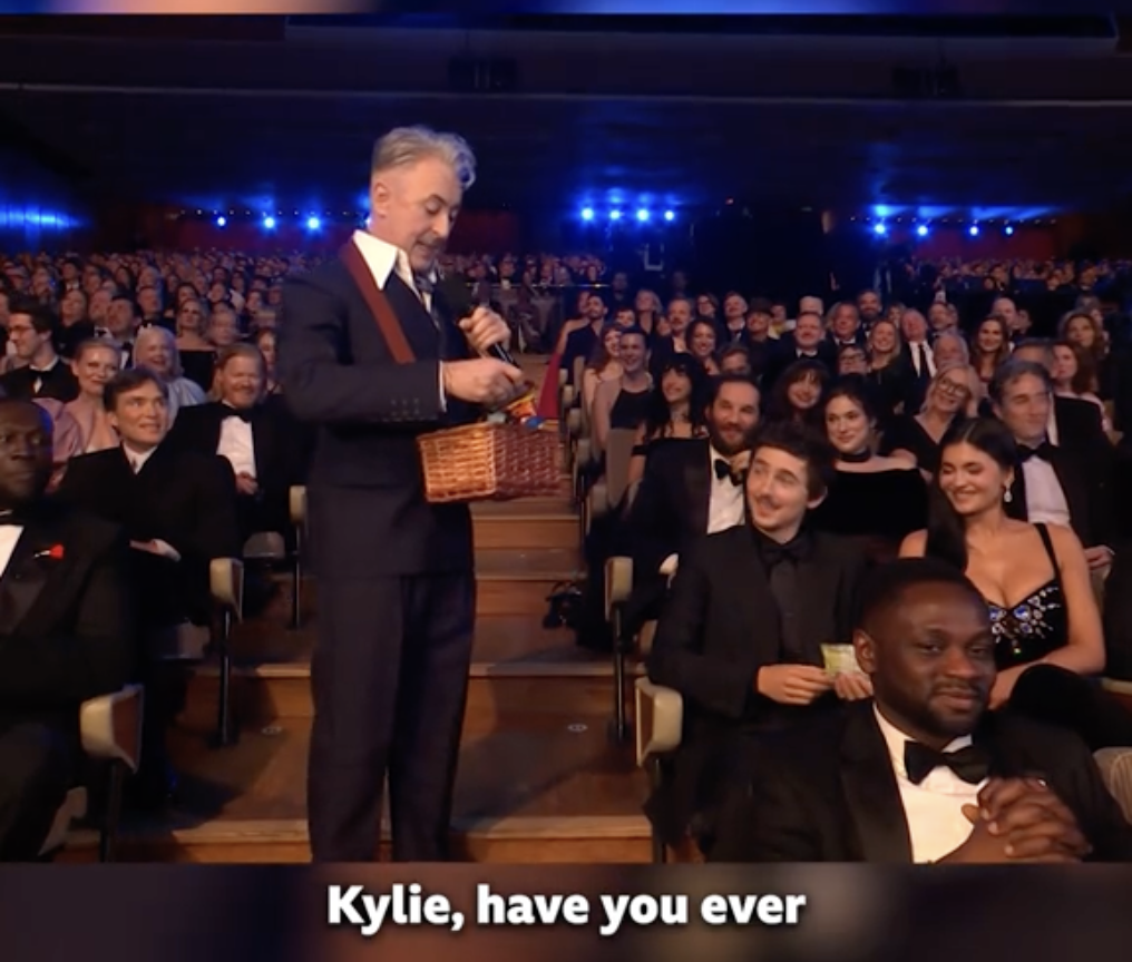 Alan Cumming offering a snack to Kylie Jenner at the 79th BAFTA Film Awards dated February 22, 2026 | Source: TikTok/bbc
