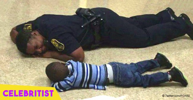 Touching moment police officer gets on the floor to comfort little boy having a 'bad day'