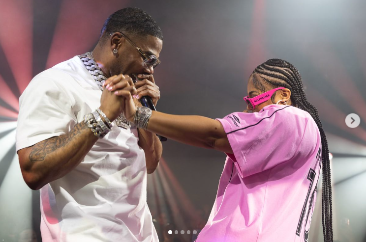 Nelly holds Ashanti's hands and sings to her during a performance on stage. | Source: Instagram/nelly