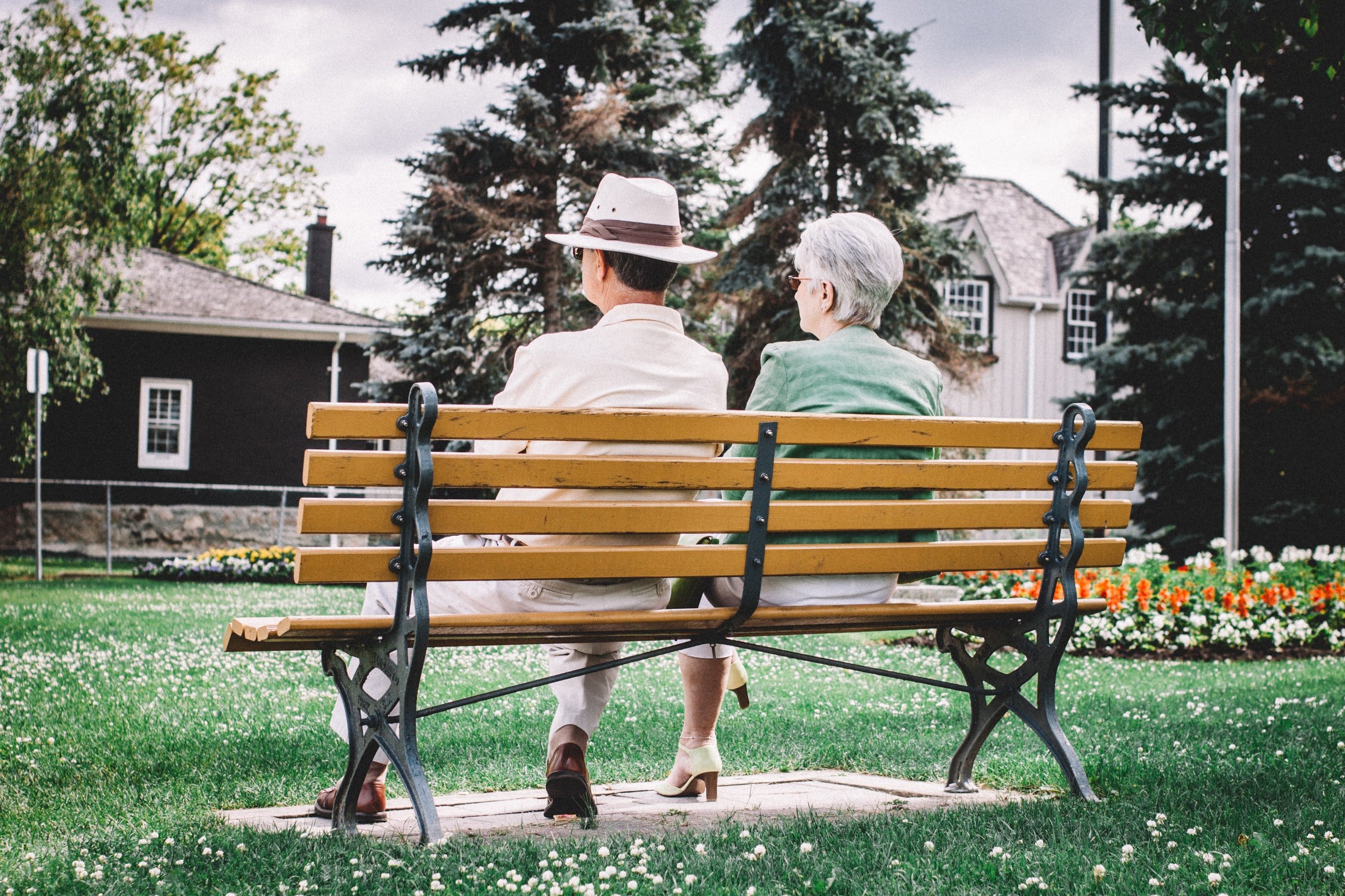 Elderly couple sitting on a bench. | Source: Unsplash