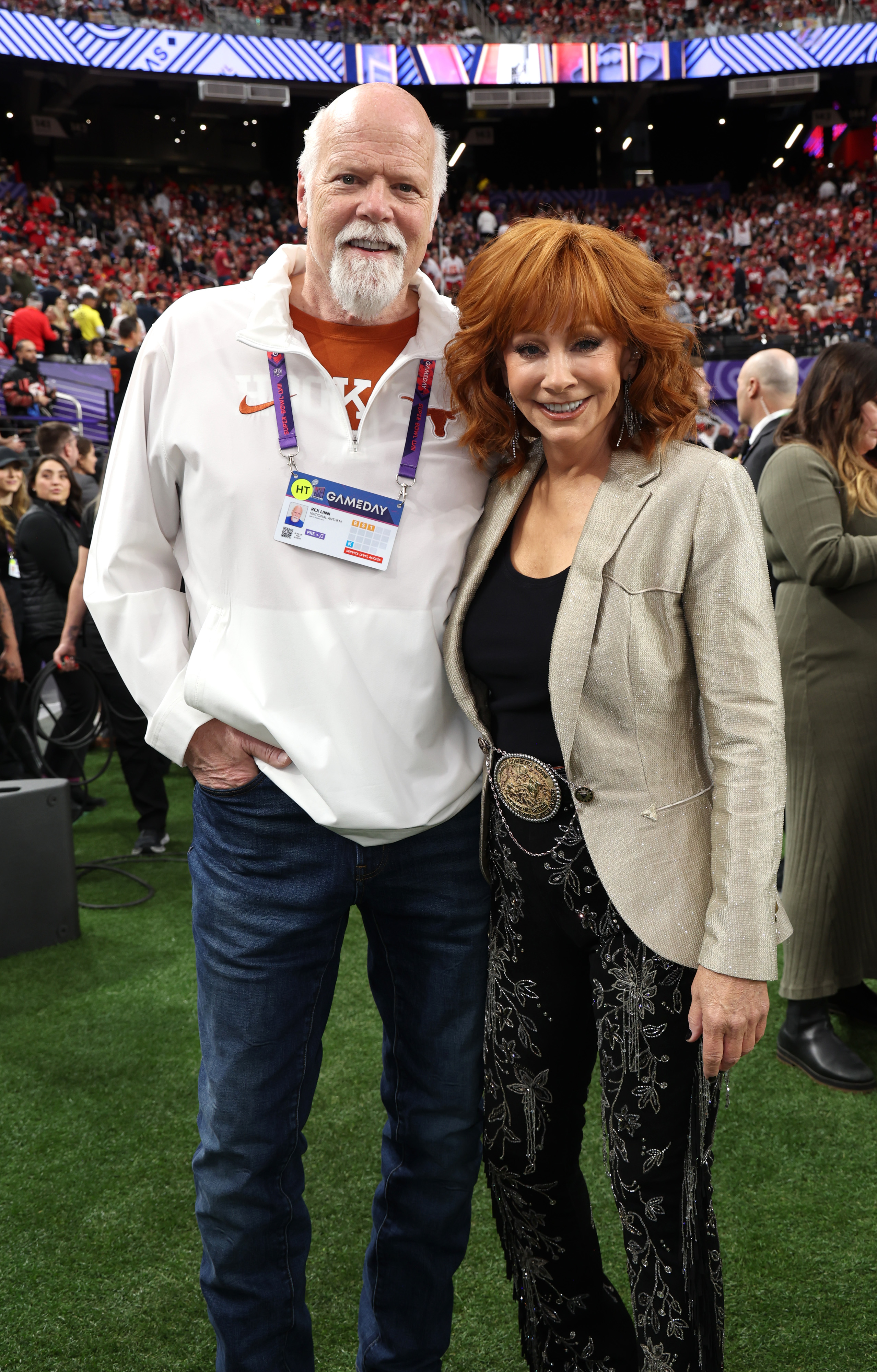 On February 11, they attend the Super Bowl LVIII pregame. They stand close on the field, with Linn's arm behind McEntire's waist and her hand resting at his lower back.