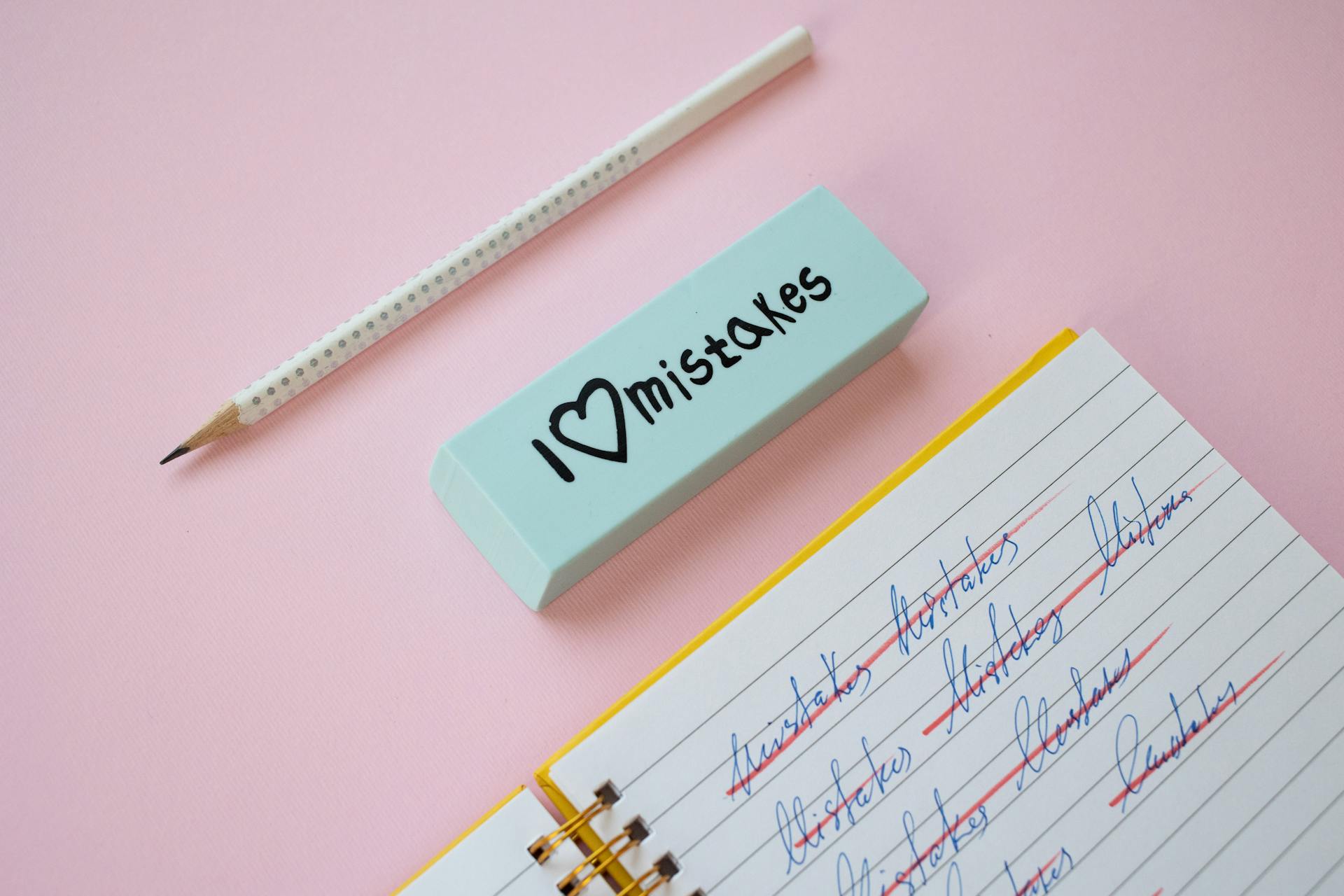 A pencil and an eraser lying next to a notebook | Source: Pexels