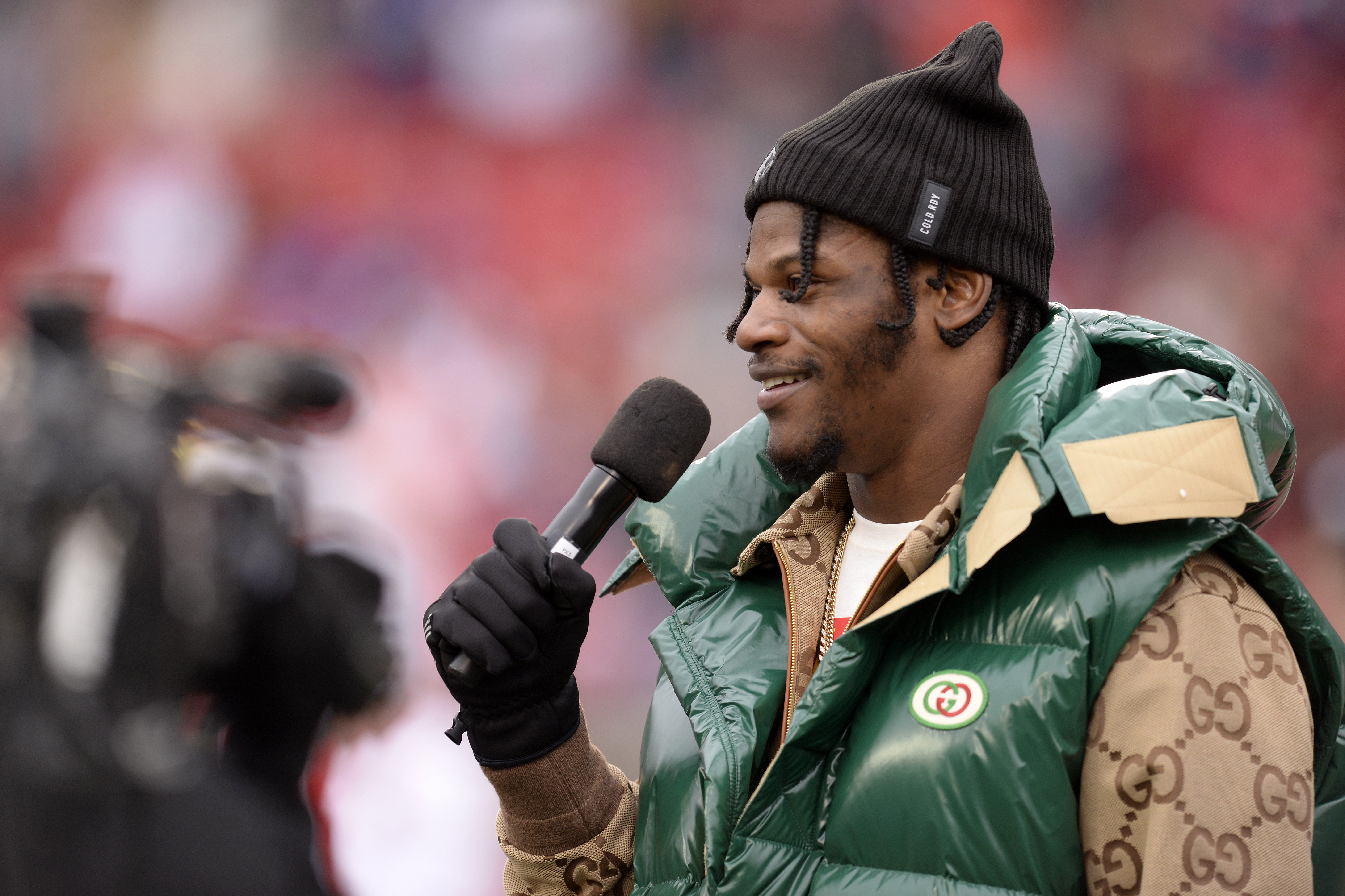 Lamar Jackson speaks to the crowd during a jersey retirement ceremony at Cardinal Stadium in Louisville, Kentucky, on November 13, 2021. | Source: Getty Images