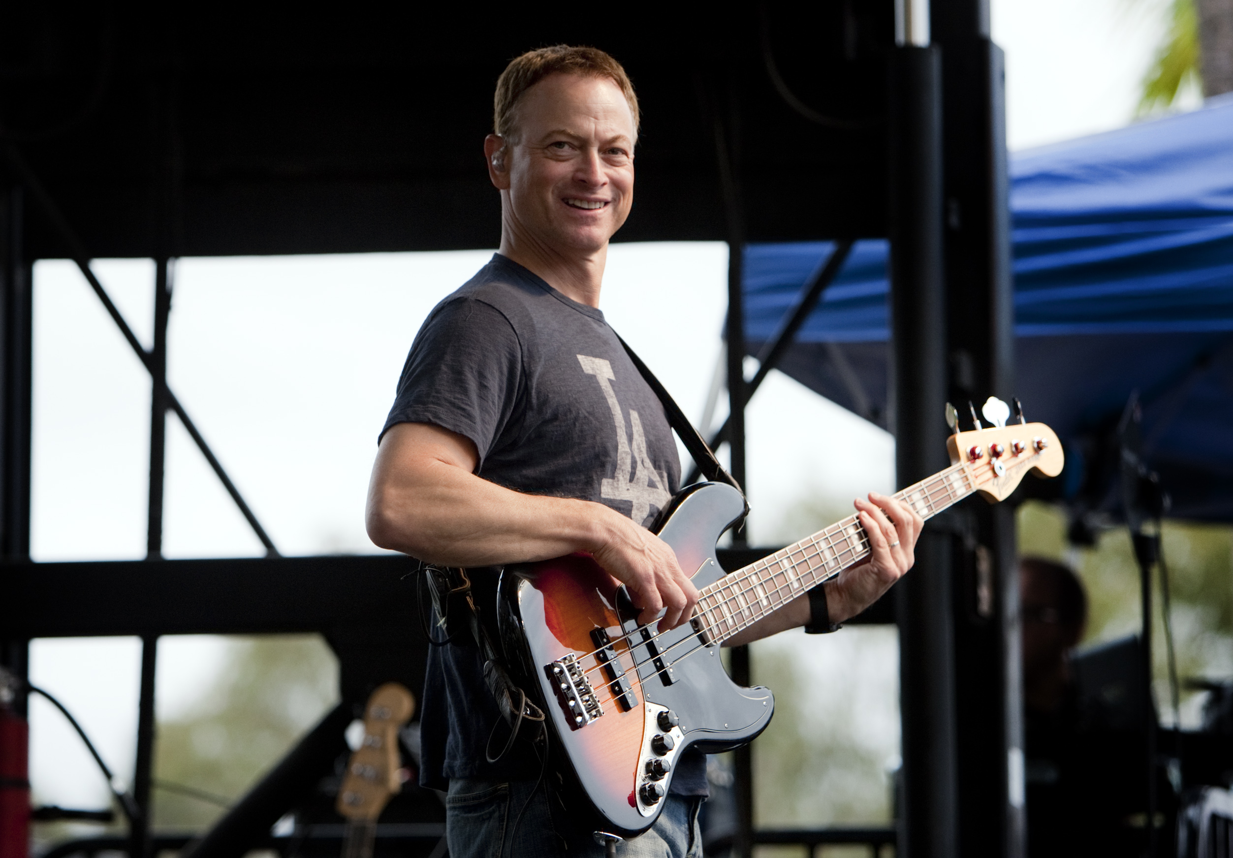 Gary Sinise on bass performing with his Lt. Dan Band for the wounded warriors, their families and hospital staff in front of the Naval Medical Center in San Diego on October 20, 2012 | Source: Getty Images