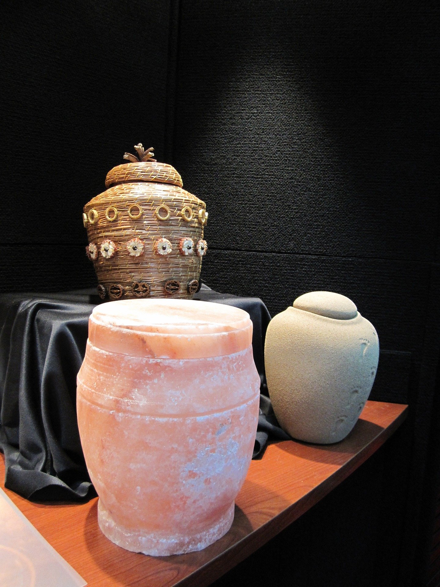 Pictured - Three different types of urns placed on a brown table | Source: Pixabay 