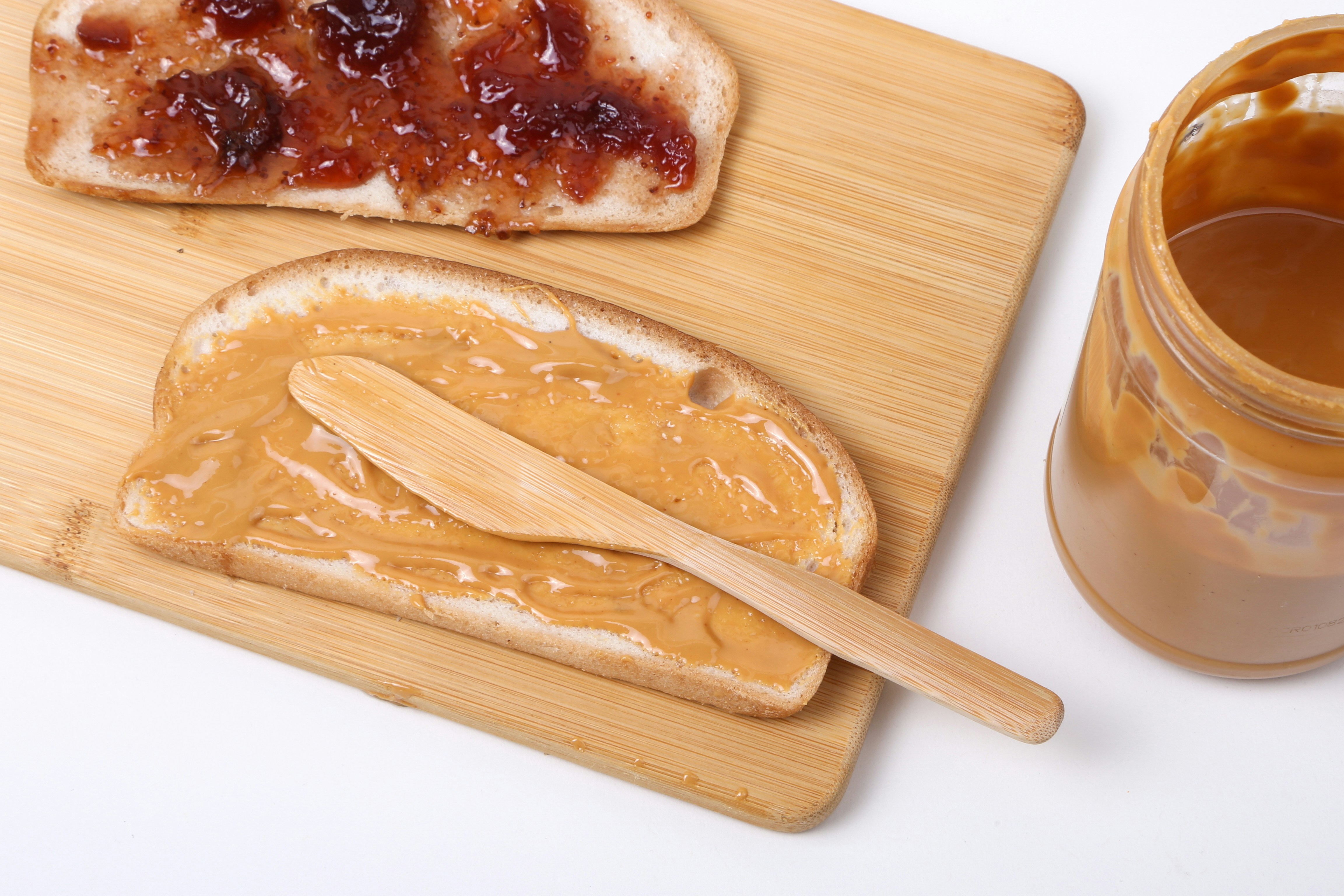 Peanut butter and jam on bread slices | Source: Unsplash