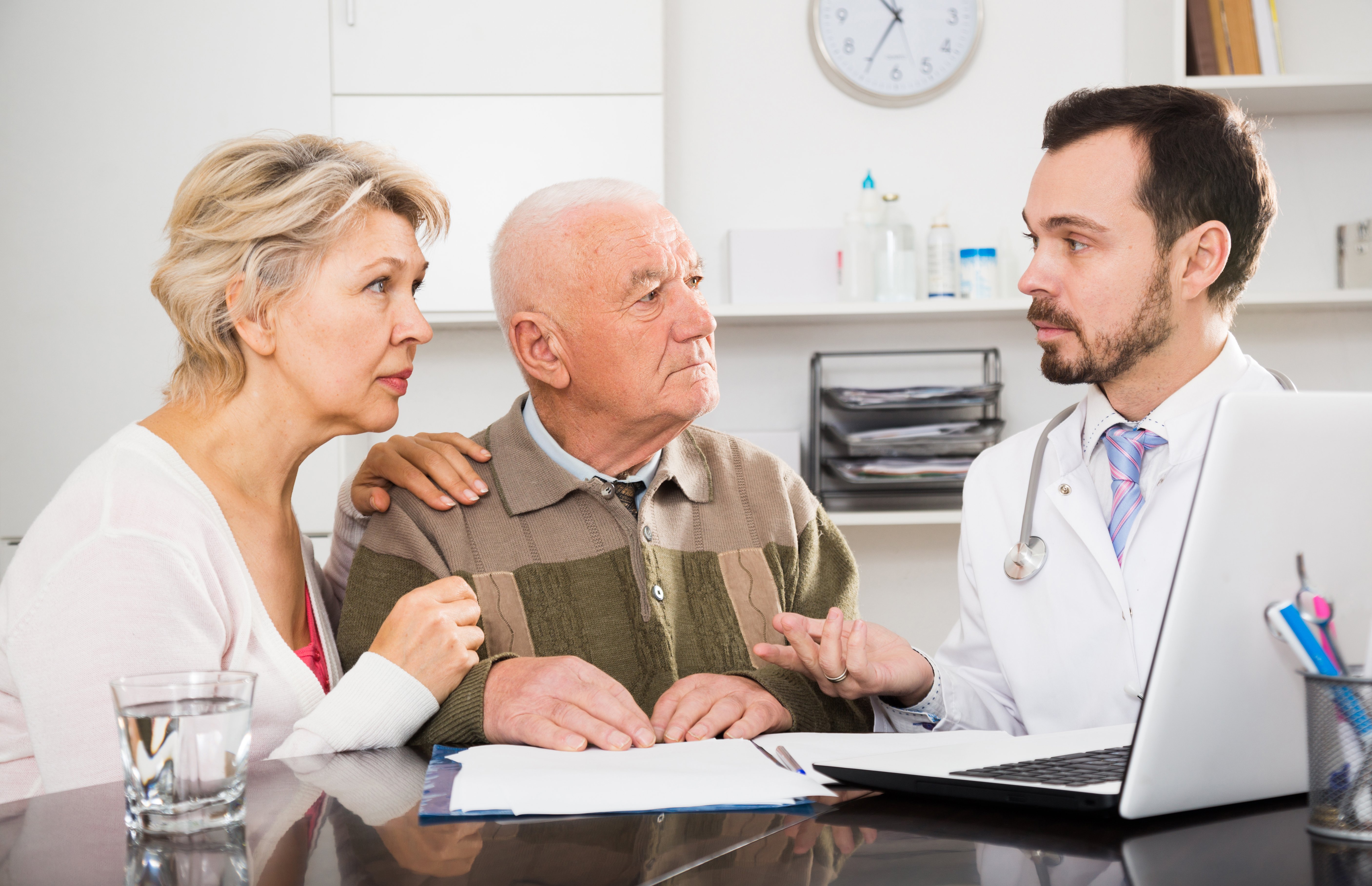 Husband and wife consulting doctor in hospital. | Source: Shutterstock