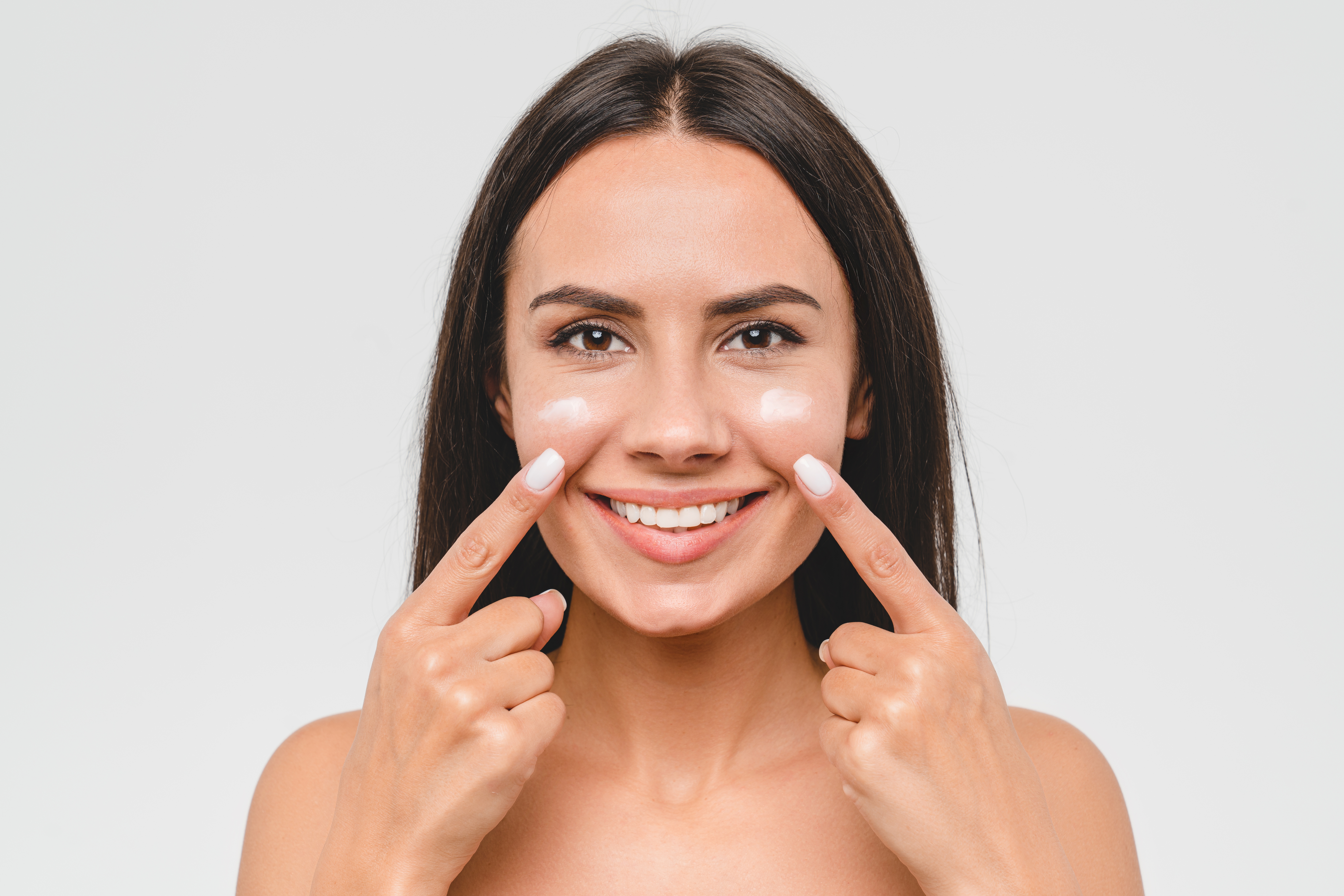 Woman with Sunscreen on her face | Source: Shutterstock