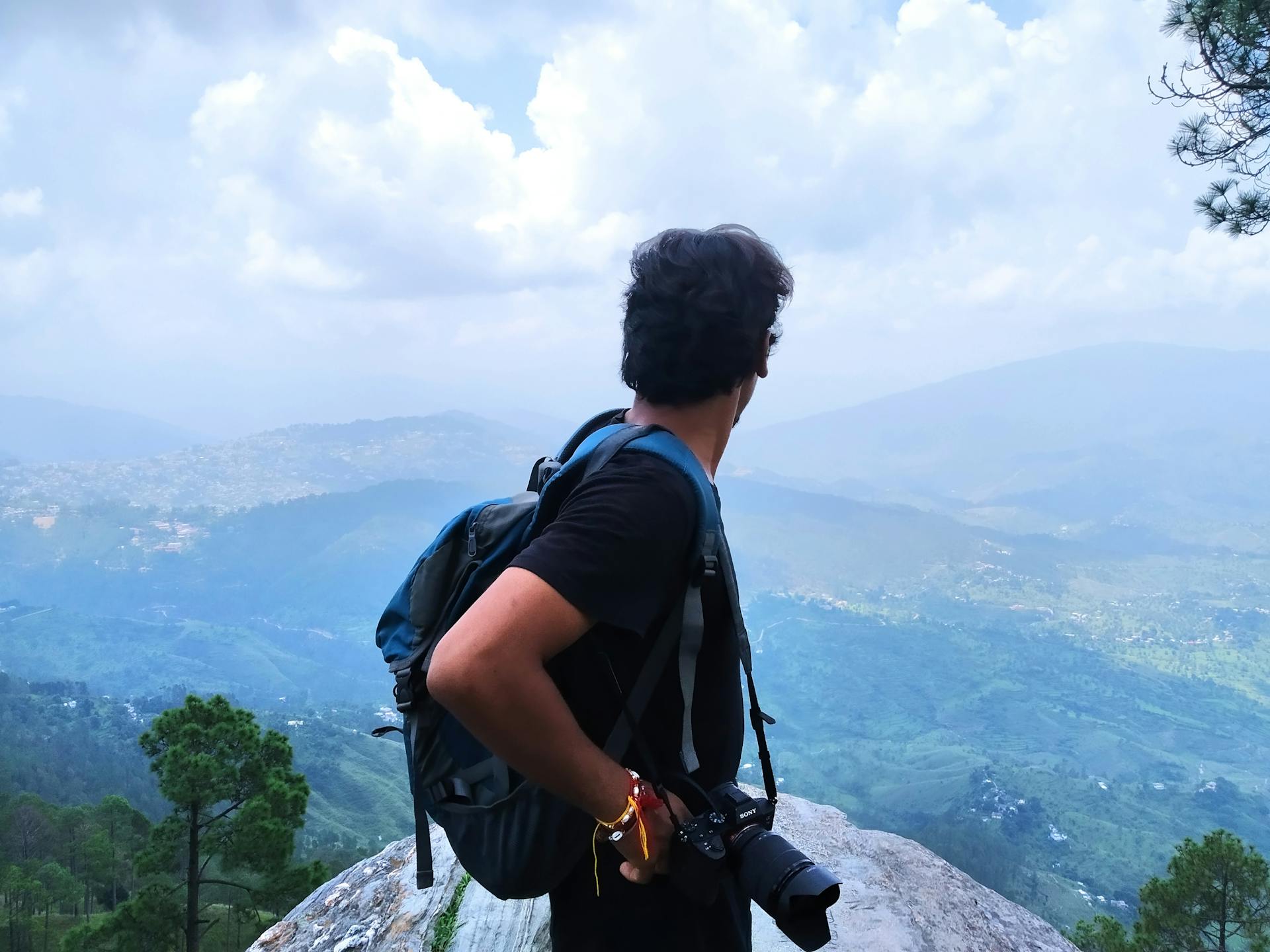 A photographer standing on top of a mountain | Source: Pexels