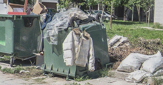 A jacket hanging from a dumpster | Source: Shutterstock