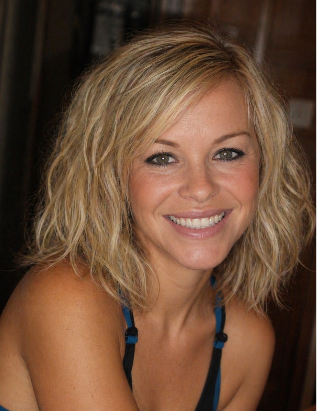 In this softly composed image, Katie Piper's hair is styled in loose, airy waves that frame her face with movement and lightness. The natural tones and subtle highlights complement her radiant expression, while the relaxed pose and minimal styling evoke a sense of calm confidence and understated charm. | Source: AI