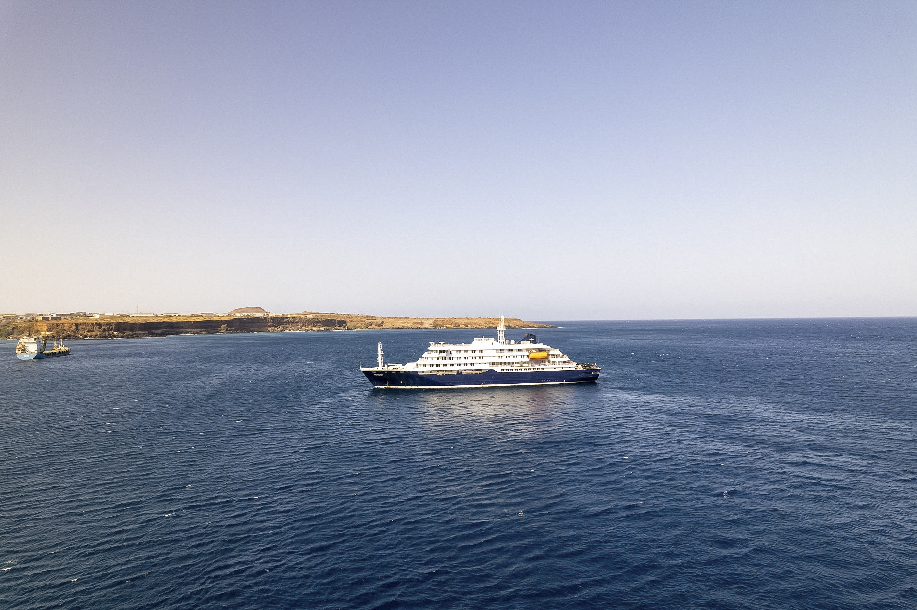 This aerial picture shows a general view of the cruise ship MV Hondius stationary off the port of Praia, the capital of Cape Verde, on 3 May 2026. | Source: Getty Images