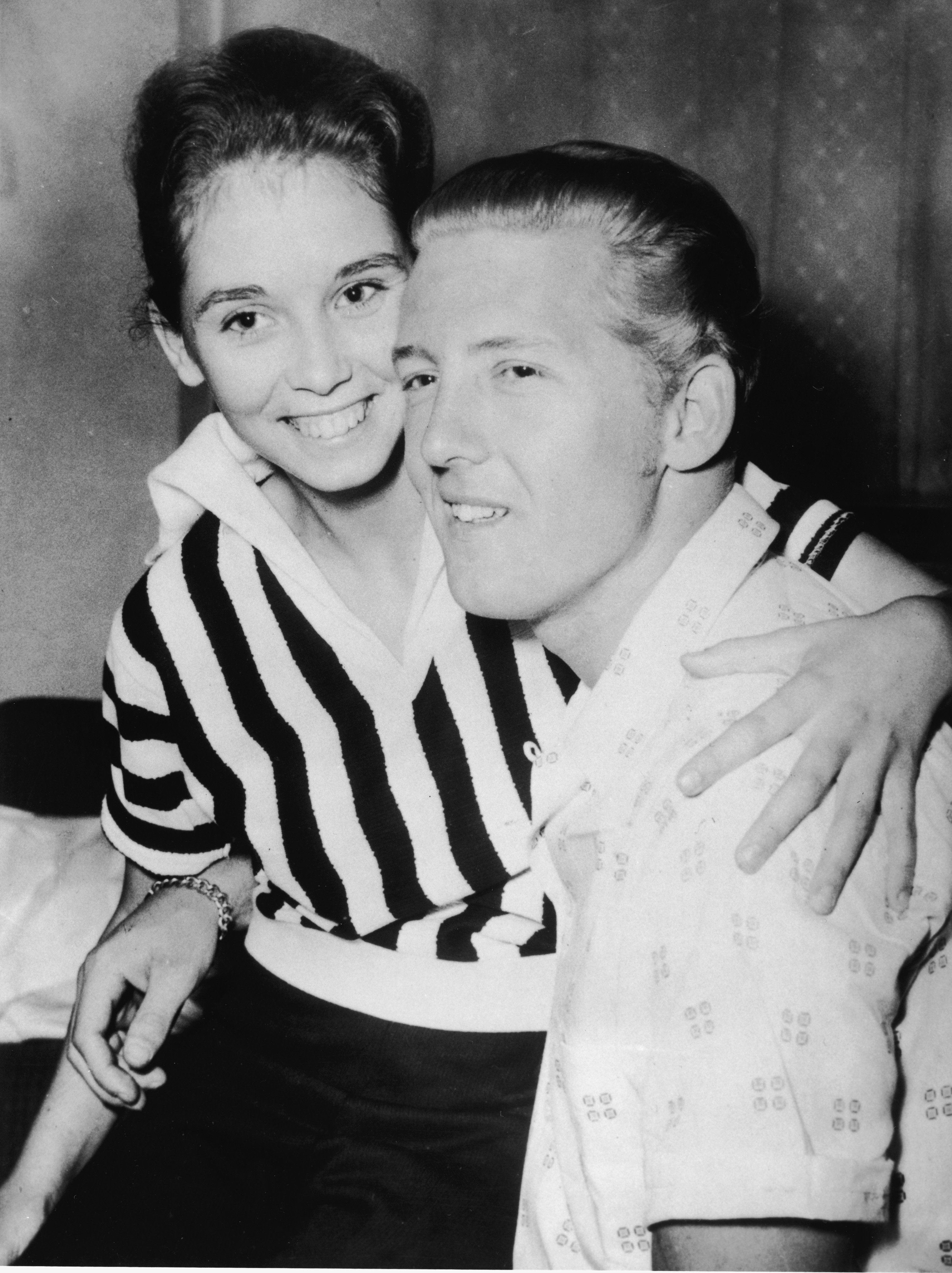 Jerry Lee Lewis holds Myra Brown in his lap at a press conference in the Westbury Hotel, London, May 23, 1958. | Source: Getty Images