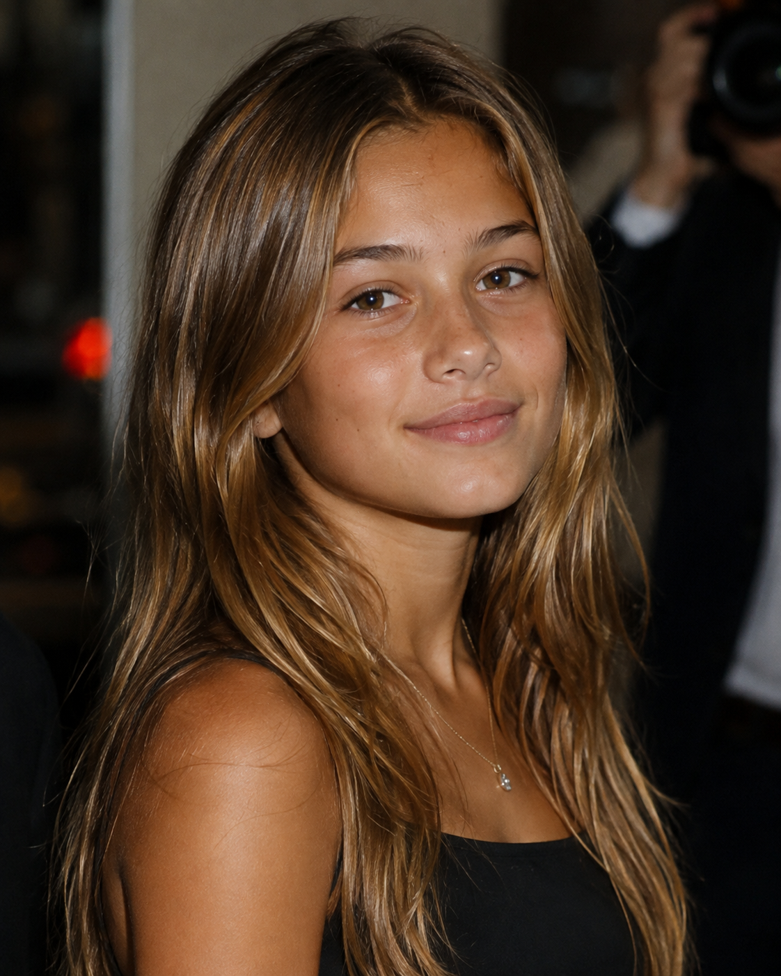In this AI creation, Fabio and Pamela Anderson’s imagined daughter smiles in a close-up portrait with sun-kissed hair, reminiscent of typical celebrity youth headshots. | Source: ChatGPT