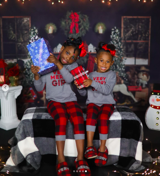 Two of Tanasha Faulk's daughters posing with presents, posted on December 16, 2021. | Source: Instagram/4ebandz