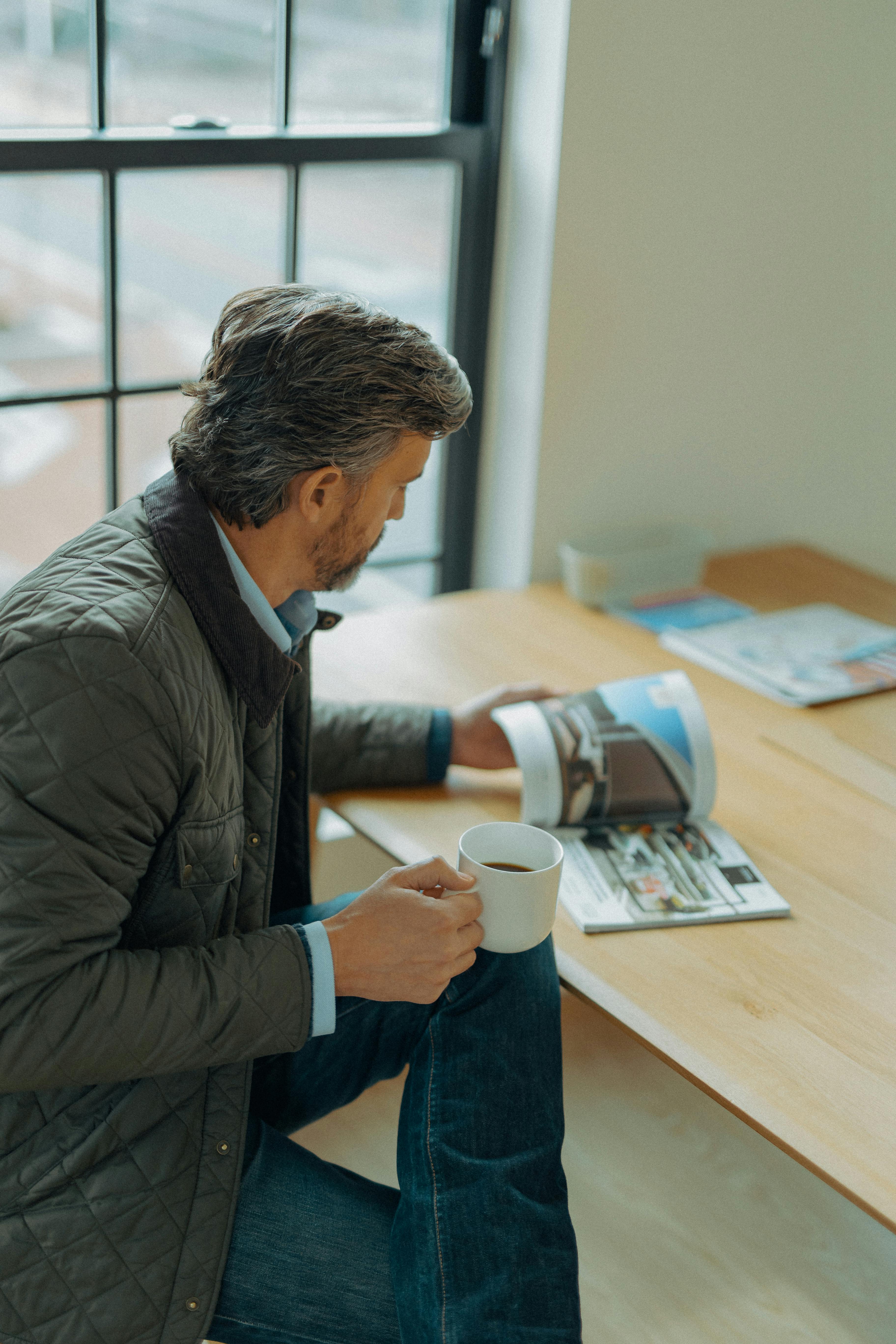 A man going through a brochure | Pexels