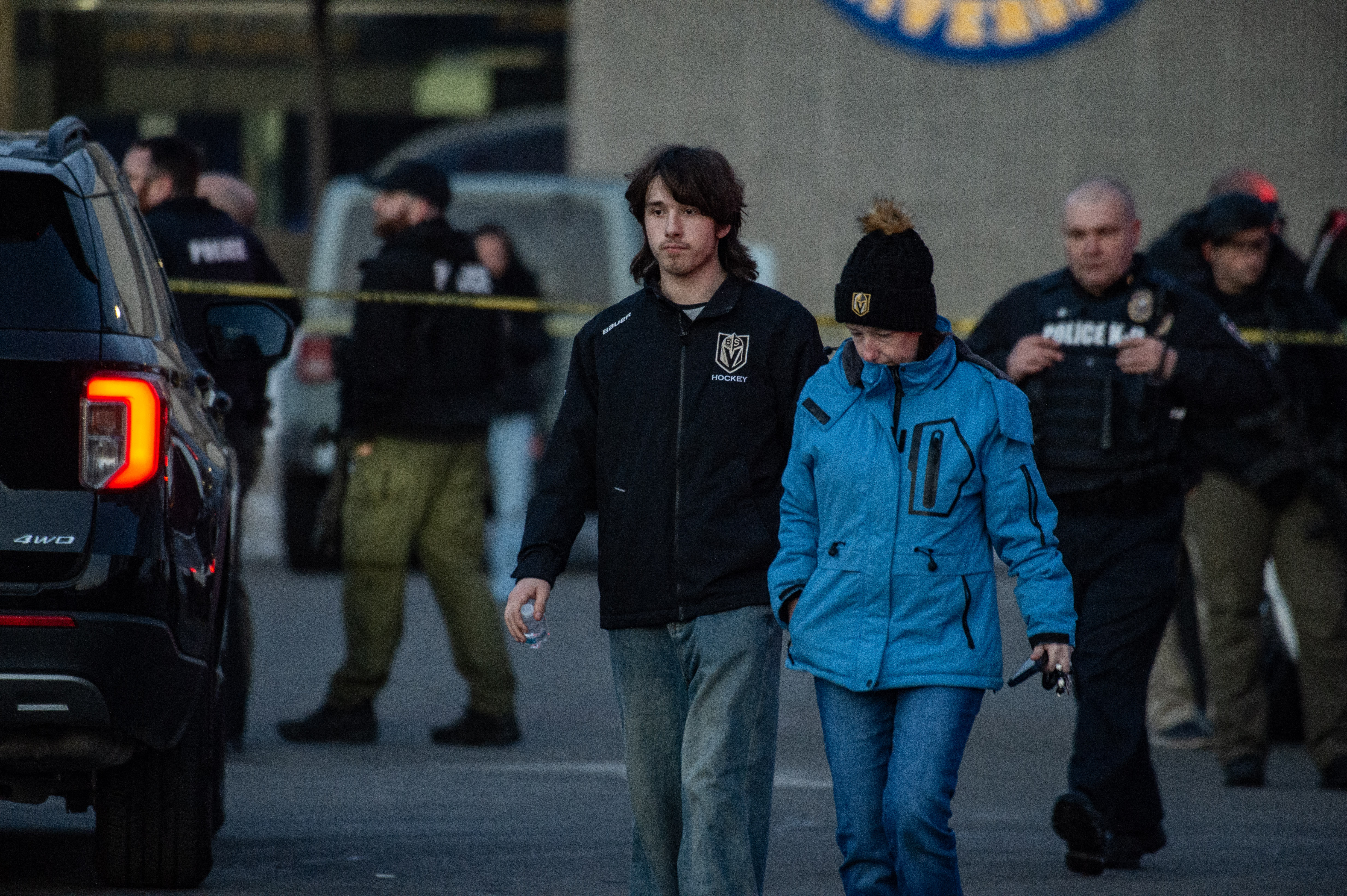 People walk past a police perimeter outside Dennis M. Lynch Arena after a shooting in Pawtucket, Rhode Island | Source: Getty Images