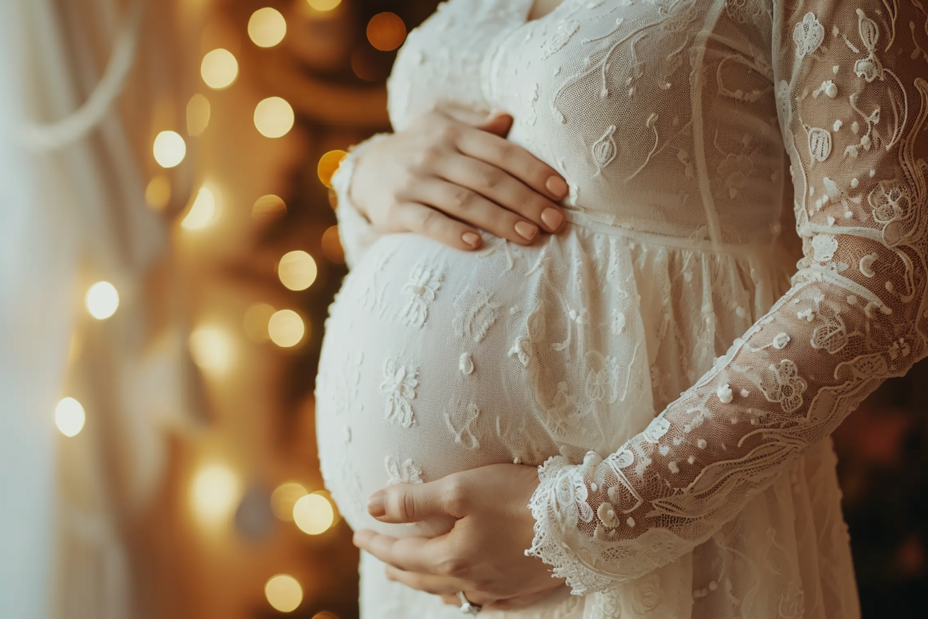 A closeup shot of a pregnant woman circling her baby bump | Source: Midjourney