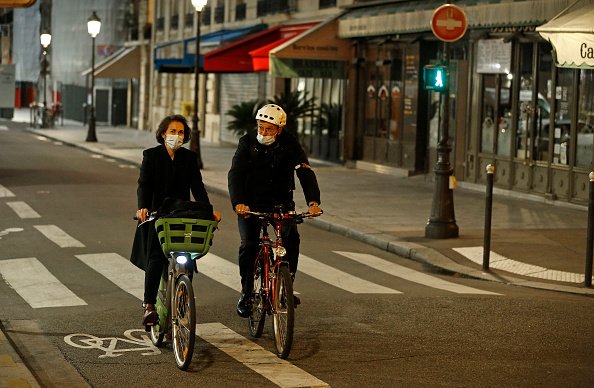 Un couple portant un masque facial de protection fait du vélo.|Photo : Getty Images