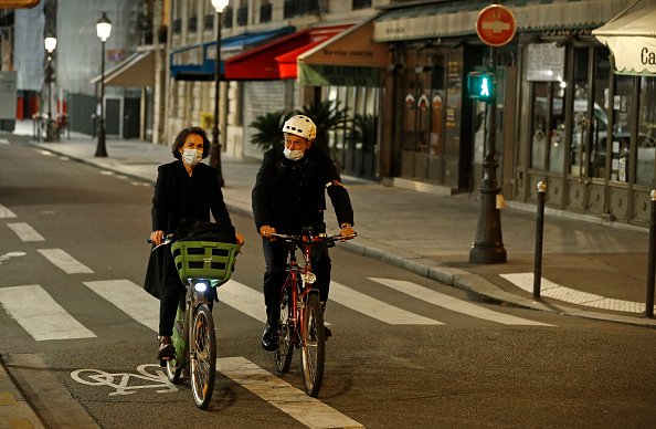 Un couple portant un masque facial de protection fait du vélo.|Photo : Getty Images